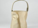 an image of a beige purse on a white background