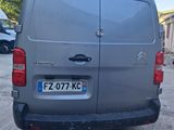 the back of a grey van parked in a parking lot