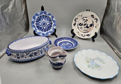 a lot of blue and white plates and bowls on the table