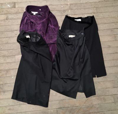 two pairs of black and purple pants on a wooden floor