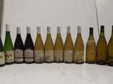 many bottles of wine lined up on the counter