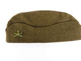 an army hat with a cross on it on a white background