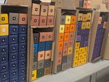 many boxes that are stacked on a shelf in a store