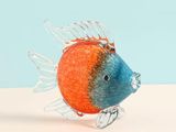 a glass fish figurine sitting on a table