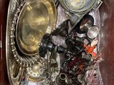 a brown box filled with silver and silverware