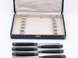 five knives in a case and six knives in the case