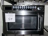 a microwave sitting on a shelf in a kitchen
