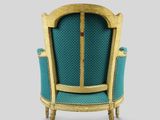 a blue chair with gold trim and a wooden frame