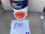 a close up of a can of paint and a note on the ground