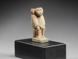 an egyptian carved figurine of a man holding a bird