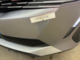 the front end of a car with a sticker on it ' s bumper