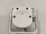 a close up of a white electrical device on a table