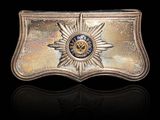 a close up of a metal belt buckle with a star on it