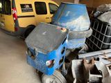 a yellow van parked next to a pile of junk in a garage