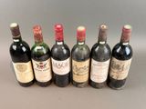 several bottles of wine are lined up in a row