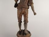 bronze statue of a man holding a baseball bat on a pedestal