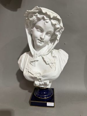 a white bust of a woman on a blue base
