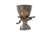 a silver cup on a stand with a bird on it