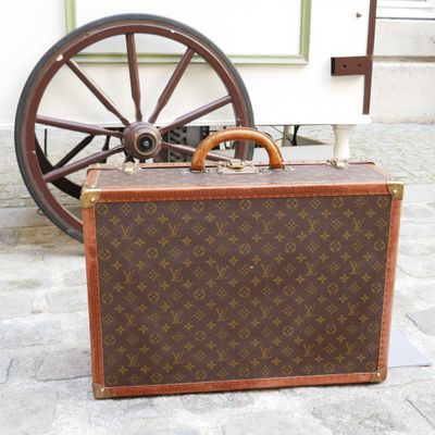 a suitcase sitting on the ground next to a wheel