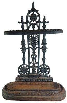 an old cast iron cross on a wooden stand on a white background