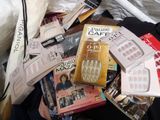 a pile of books and magazines on a bed