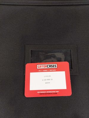 a close up of a black bag with a red tag on it