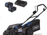 a blue and black corded lawn mower with two batteries
