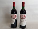 two bottles of red wine sitting next to each other on a table