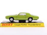 a green toy car sitting on top of a box