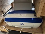 a blue and white printer sitting on top of a wooden pallet