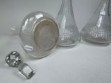 two glass vases and a metal knob on a table