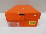 an orange nike shoe box sitting on top of a white table