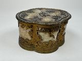 a gold and white box sitting on a white surface