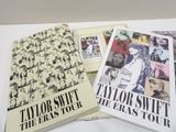 three books on a table with a white background and a black and white photo