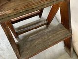 a wooden step stool that is sitting on the floor