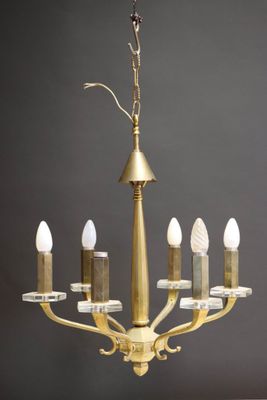 a close up of a chandelier with five candles on it