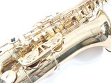 saxophone on a white surface with a white background