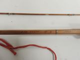 two fishing rods that are next to each other on a table