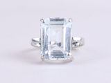 a close up of a ring with an aquamarine stone in it