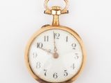 a close up of a gold pocket watch on a white background