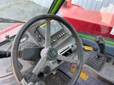 a steering wheel of a tractor that is sitting on the ground