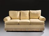 an image of a beige couch with two pillows on top of it