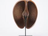 a close up of a sculpture of an apple on a stand