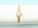 a close up of a watch on a napkin on a blue background