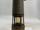 an old fashioned oil lamp on a white surface with a white background