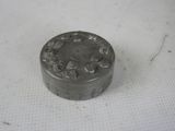 a small metal object on a white surface