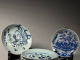 several blue and white plates are stacked on top of each other