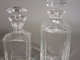two glass bottles that are sitting next to each other