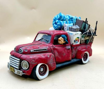 a toy truck with a bunch of items in the back