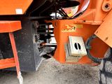 a close up view of the front end of an orange tractor